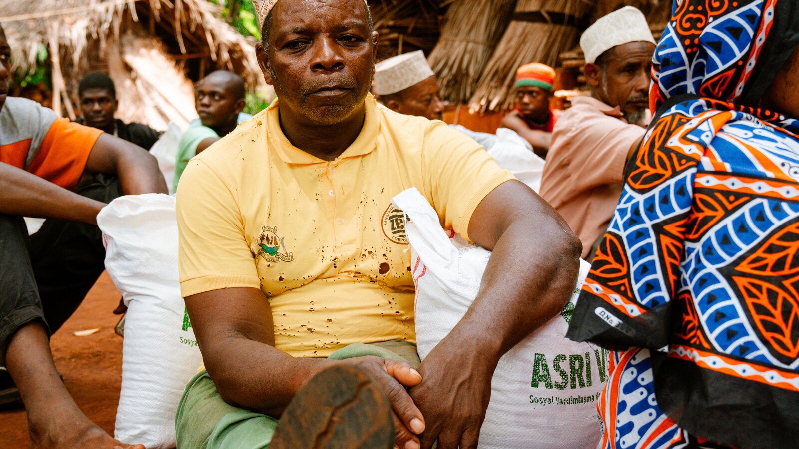 A community meeting under a tree in a rural village